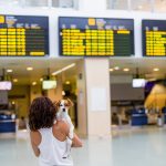 Young woman at the airport ready to travel with her dog