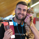 Owner holds cat in an airport