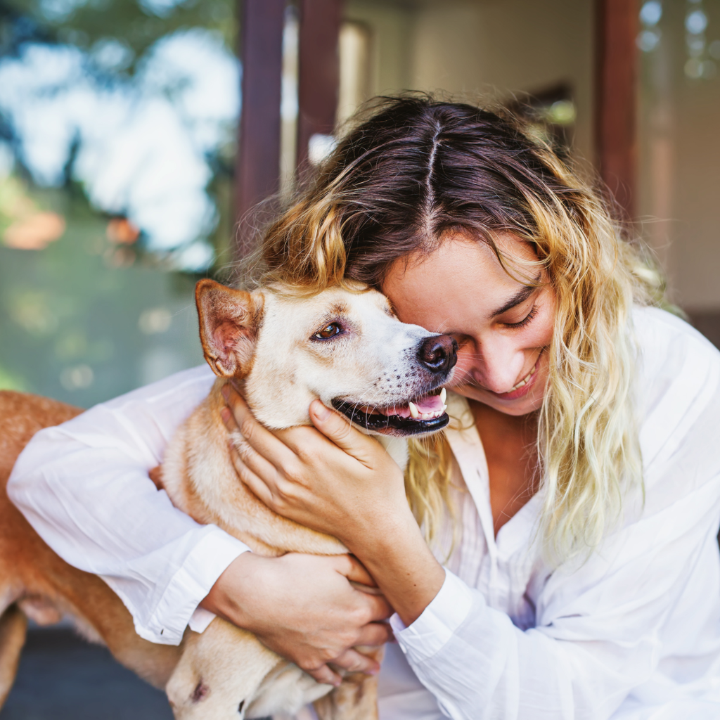 1 woman hugging her beloved pet