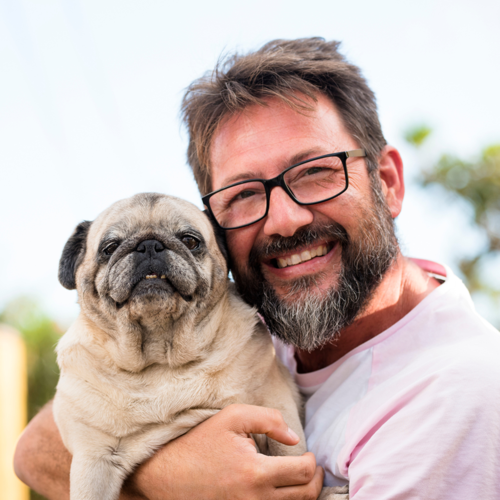 Man poses for a portrait with his dog