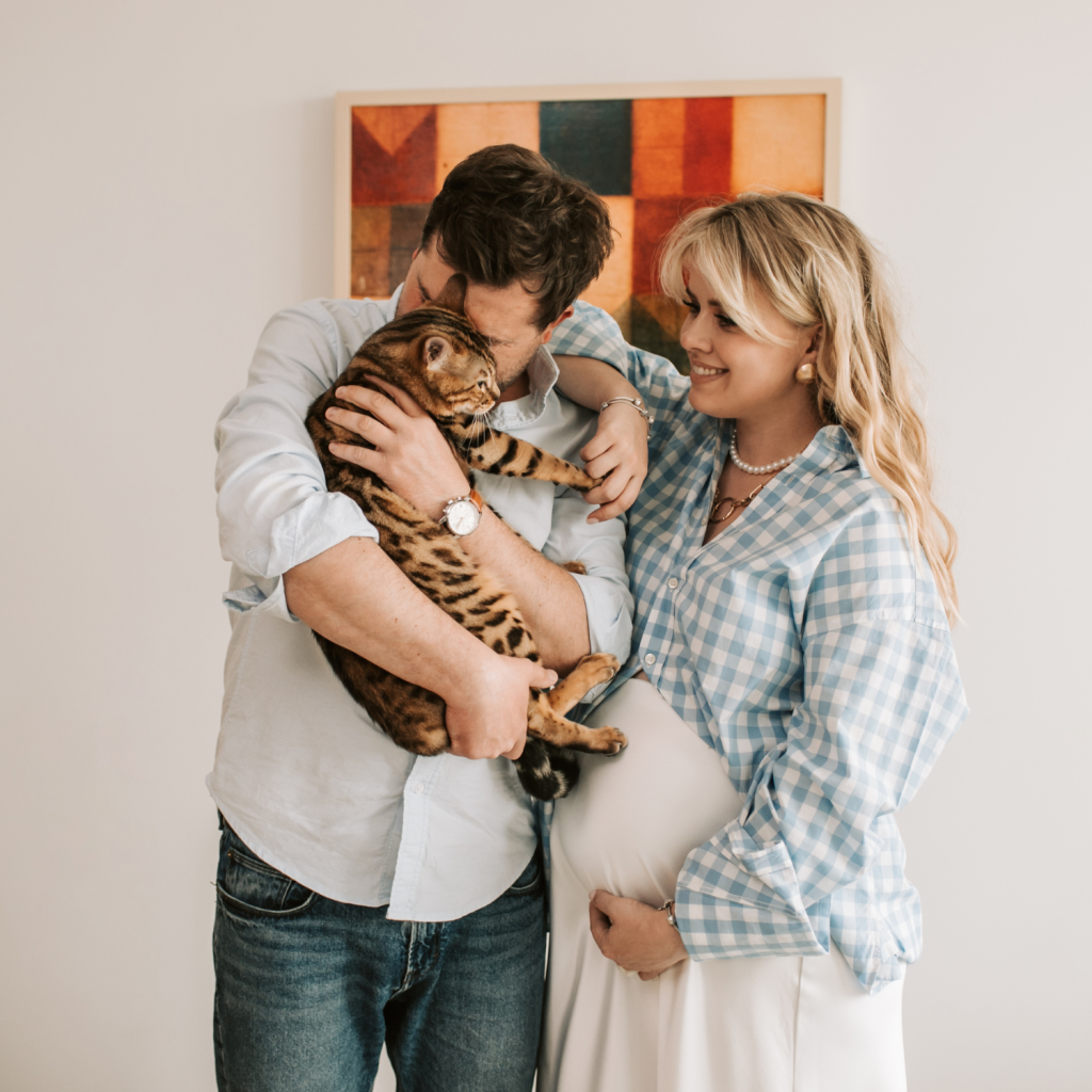 Couple embraces their pet cat